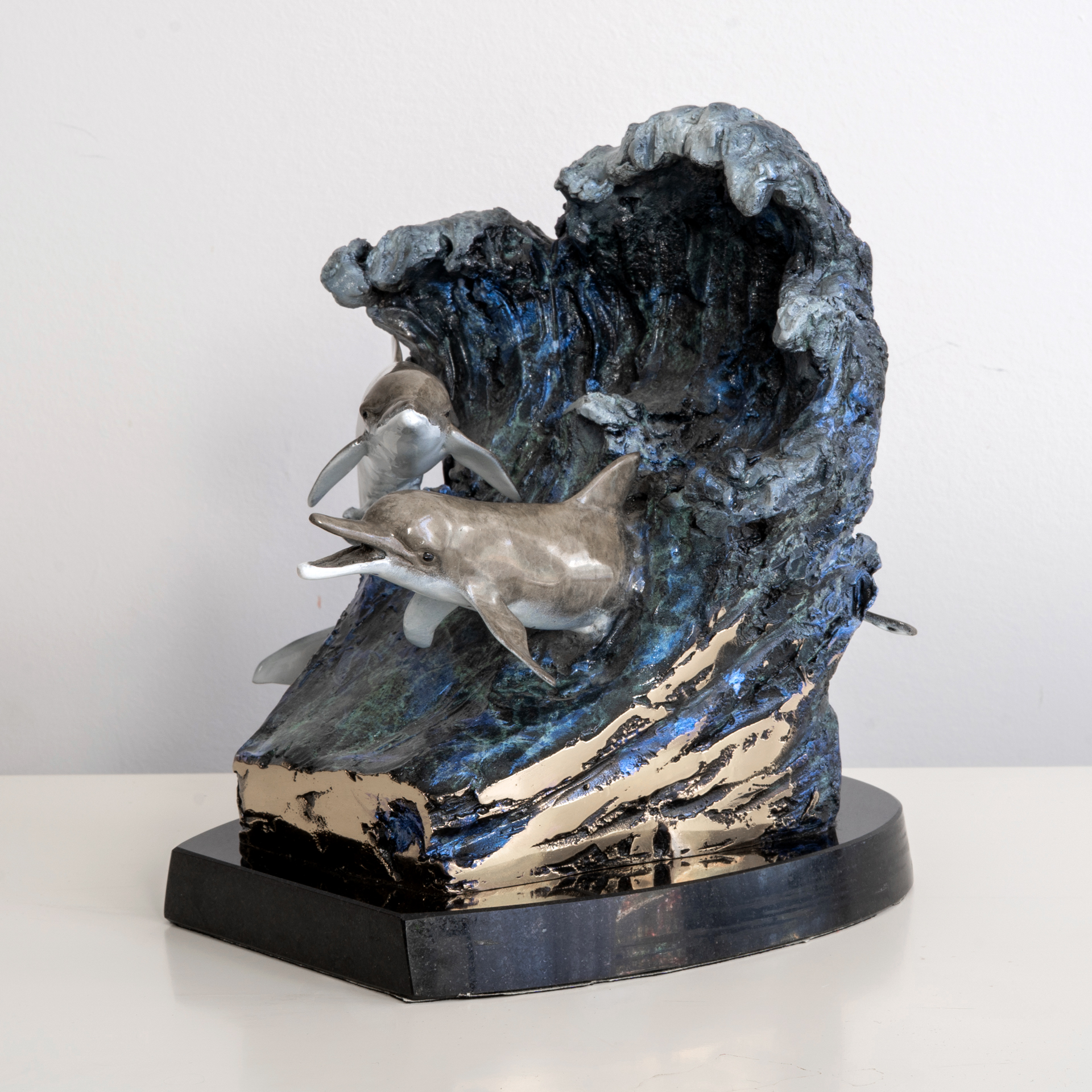 The finished bronze dolphin sculpture after patina and mounting